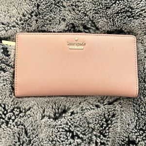 Kate spade baby pink wallet with black and white striped interior